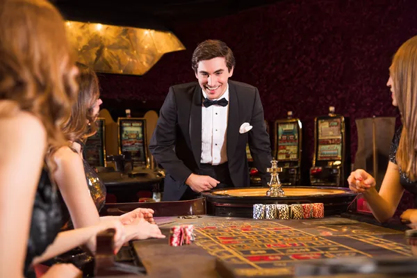 A stylish woman beside vibrant slot machines displaying glowing sevens, showcasing the variety of top slots at ZEUS75.