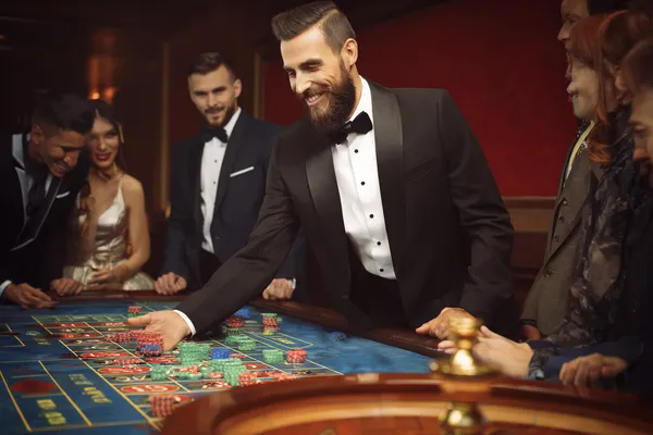 A close-up shot of golden coins falling around a spinning roulette wheel, representing immersive casino action at ZEUS75.