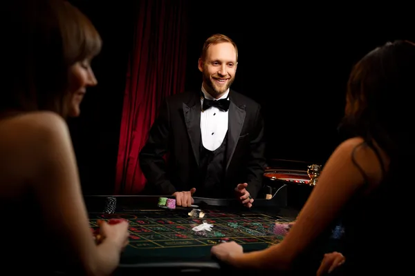 A player using their smartphone during a festive local event, representing ZEUS75’s fully mobile-friendly casino.